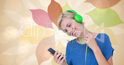 Happy woman listening to music using smart phone