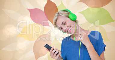 Happy woman listening to music using smart phone