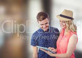 Smiling man and woman using tablet PC