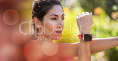 Young woman wearing smart watch while exercising