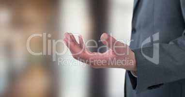 Midsection of businessman gesturing in office