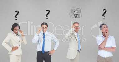 Confused business people with question marks and light bulb on gray background