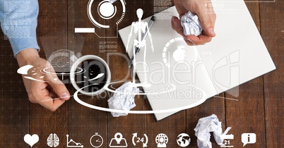 Top view of hands with paper ball and coffee cup at table