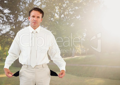 Sad businessman with empty pockets in park