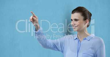 Smiling businesswoman pointing over blue background