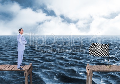 businessman with his hands folded looking to the checker flag in a quay