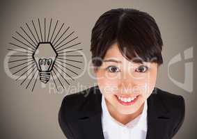 Business woman looking up against lightbulb graphic and brown background