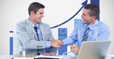 Business people shaking hands against graph