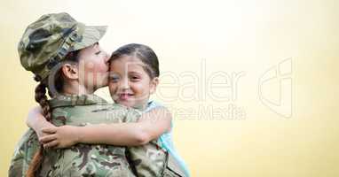 Soldier mother and daughter against yellow background