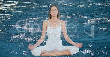 Double exposure of woman meditating over lake