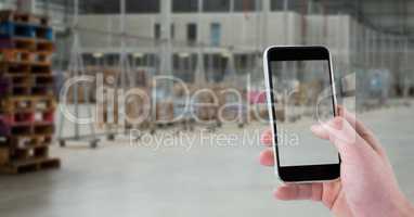 Hand photographing through smart phone in warehouse