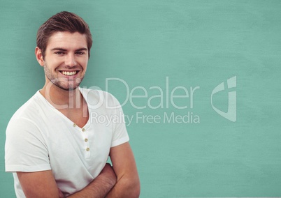 Smiling man standing arms crossed over turquoise background