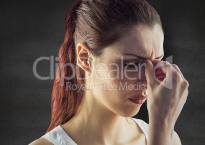 Close up of stressed woman against grey wall