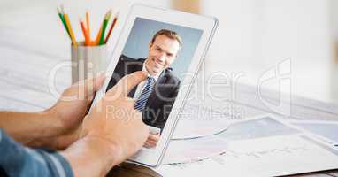 Cropped image of businessman video conferencing with colleague on tablet PC