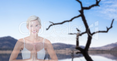 Double exposure of woman with hands clasped performing yoga