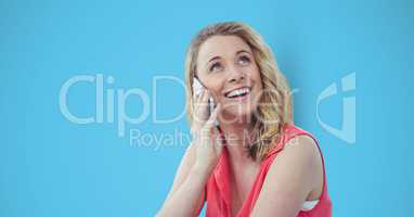 Happy female hipster using smart phone against blue background