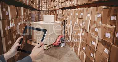 Hands taking picture with tablet PC in warehouse