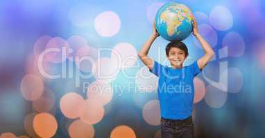 Portrait of boy carrying globe against bokeh