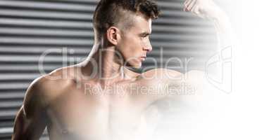 Confident shirtless man flexing muscles