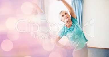 Senior woman exercising with bokeh in foreground