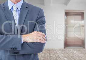 Midsection of businessman with arms crossed
