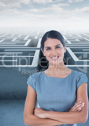 Businesswoman with arms crossed against maze