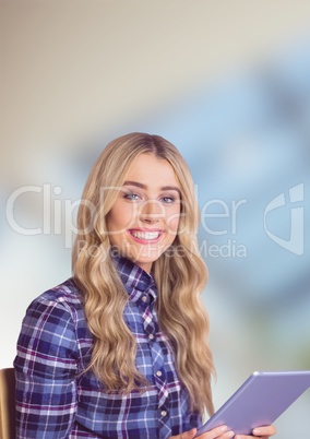 Female hipster holding digital tablet over blur background