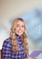 Female hipster holding digital tablet over blur background
