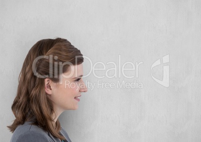 Side view of smiling businesswoman against wall