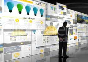 panels with websites(yellow) in dark background. Business man looking to it