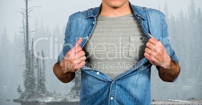 Midsection of male hipster pulling his shirt like superhero