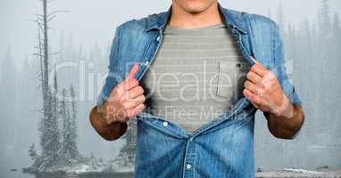 Midsection of male hipster pulling his shirt like superhero