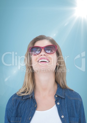 Close up of business woman with sunglasses and flare against blue background