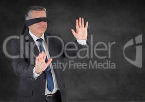 Business man blindfolded with grunge overlay against grey wall