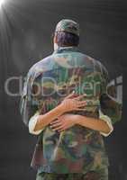 Back of soldier hugging against grey wall with flare