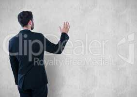 Rear view of businessman touching wall