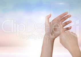 Hand touching glass screen with sky