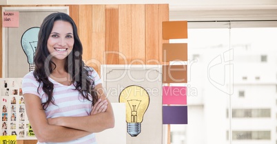 Smiling businesswoman with arms crossed against graphics