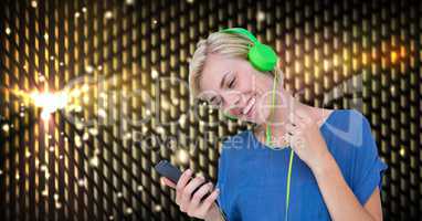Happy woman listening to music on headphones
