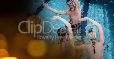 Man and women exercising in swimming pool