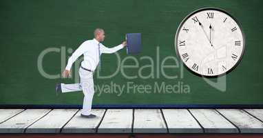 Businessman running late with clock mounted on wall