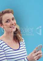 Portrait of happy woman holding smart phone against blue background