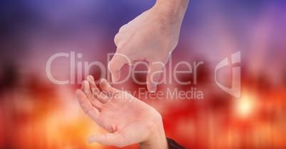 Cropped image of couple's hands against bokeh