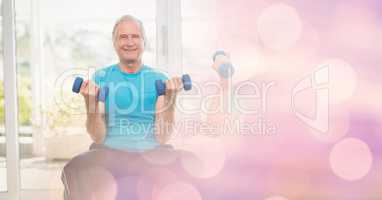 Senior man lifting dumbbells in gym