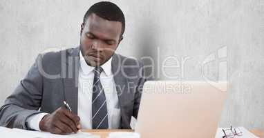 Businessman writing notes at desk