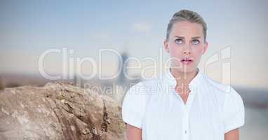 Scared businesswoman looking away by rock