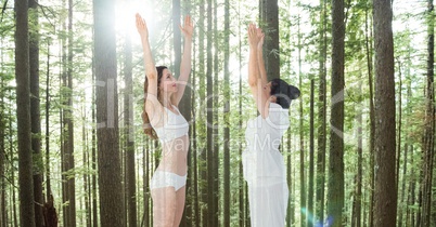 Women performing yoga against trees
