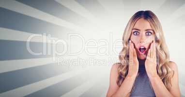 Shocked woman with hands on cheeks against bright background