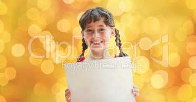 Happy girl holding placard over defocused background