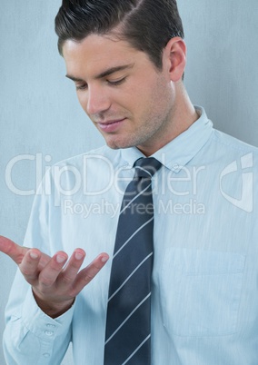 Young businessman looking at palm